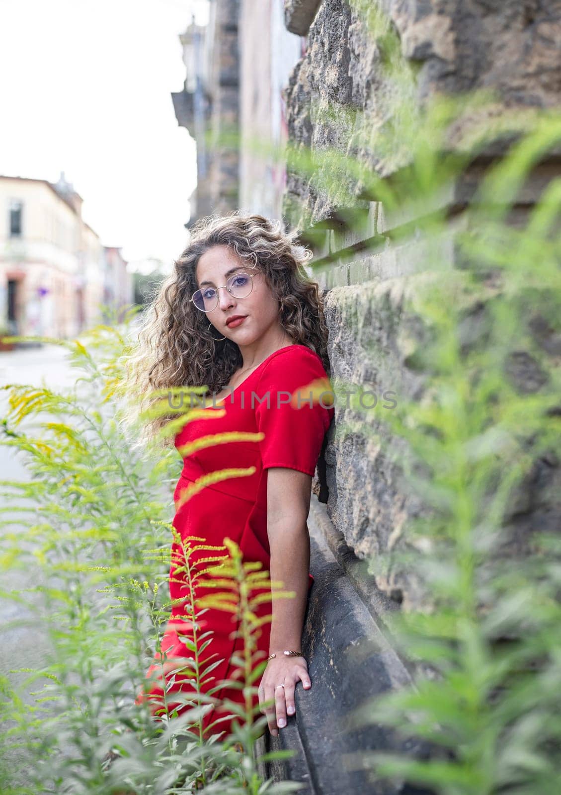 pensive young woman standing on the street