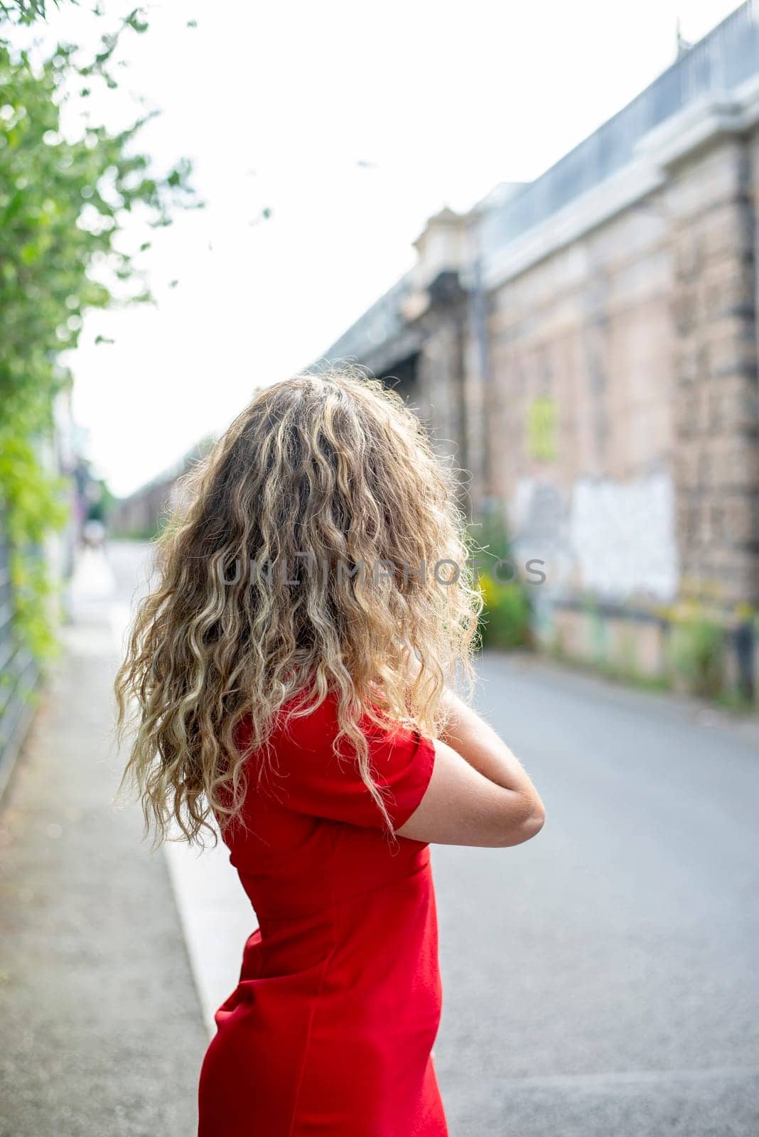 lonely young woman standing on the street
