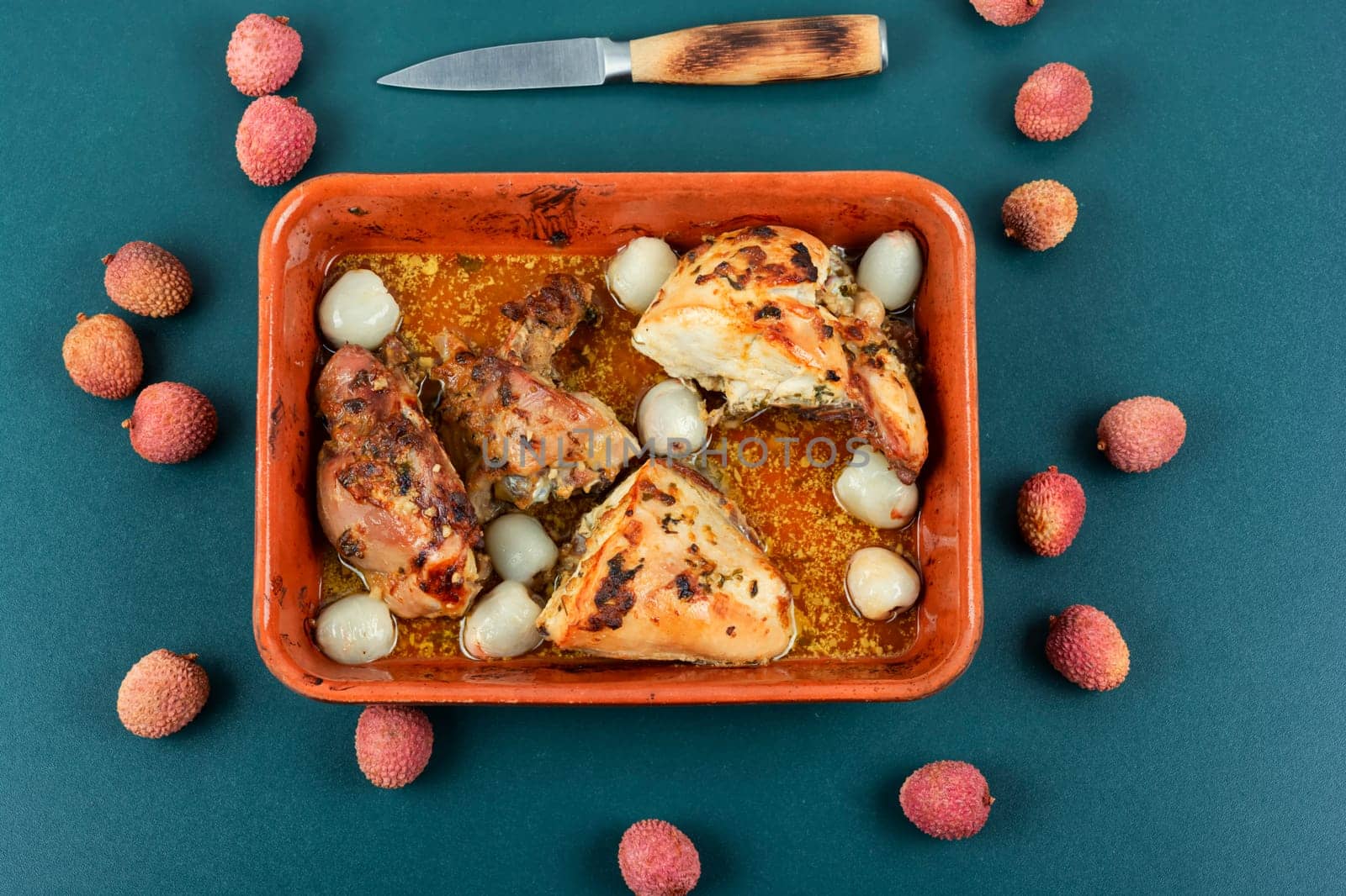 Pieces of grilled or smoked chicken meat with lychee on a plate.