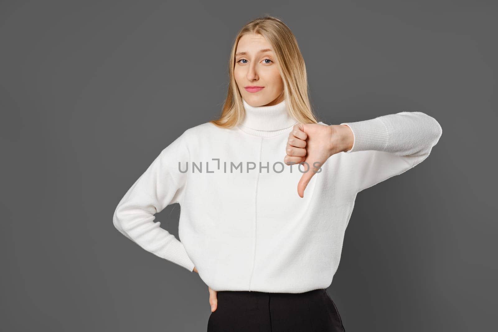The gesture of a loser. The woman gave a thumbs down.