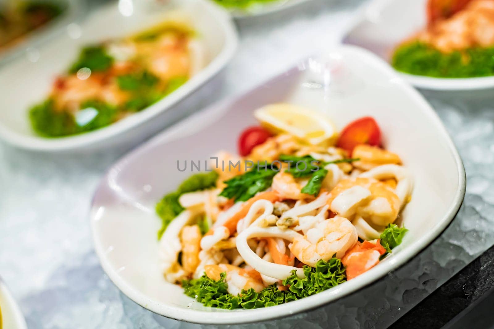 Seafood salad plates displayed in a commercial restaurant refrigerator