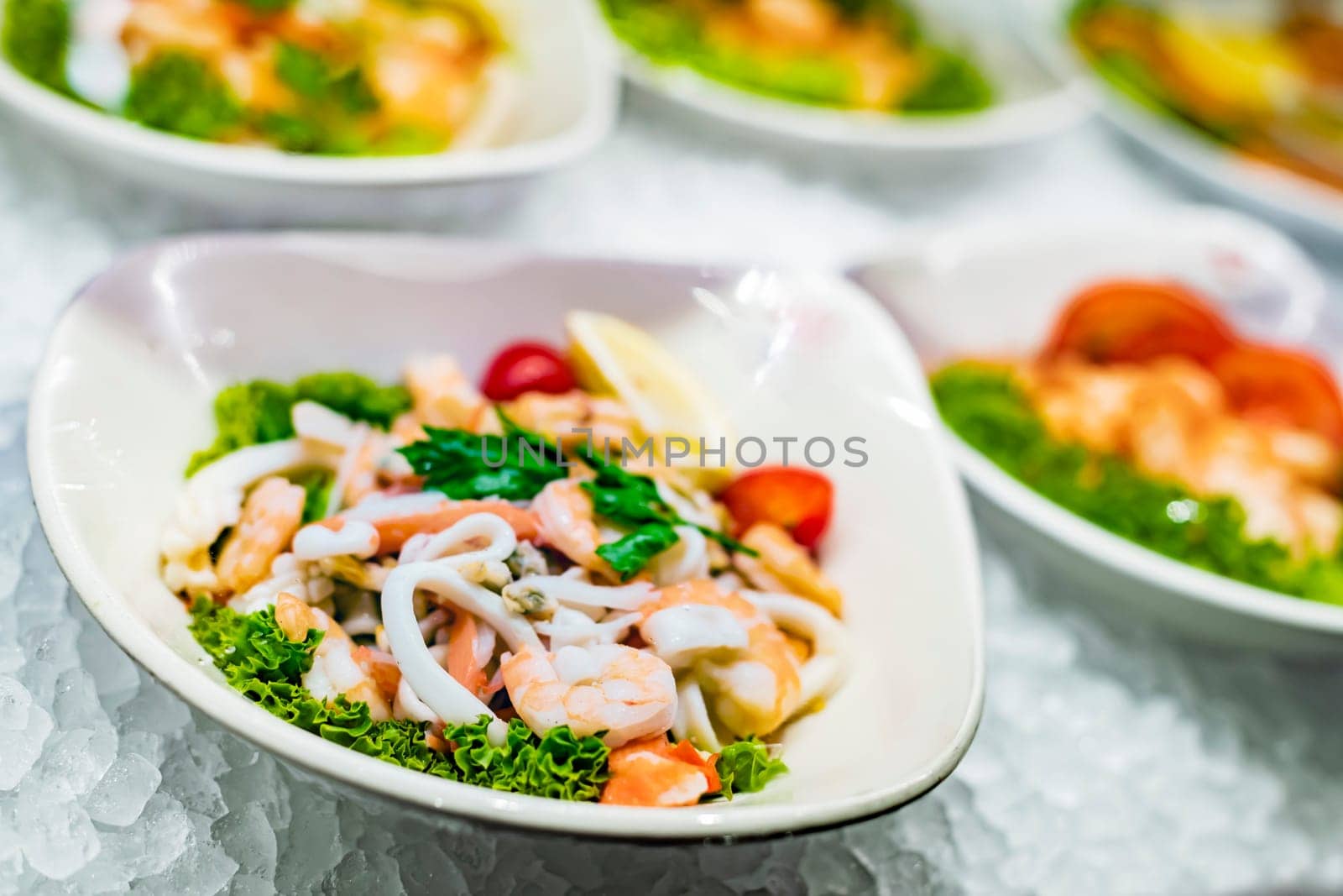 Seafood salad plates displayed in a commercial restaurant refrigerator