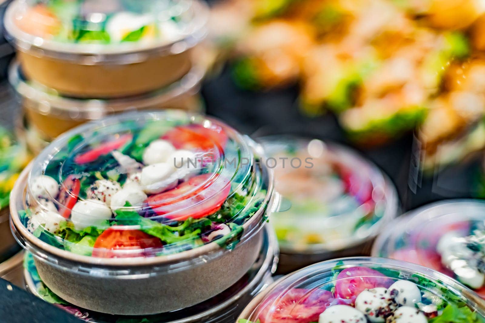 Pre-packaged ready to eat meals displayed in a commercial refrigerator
