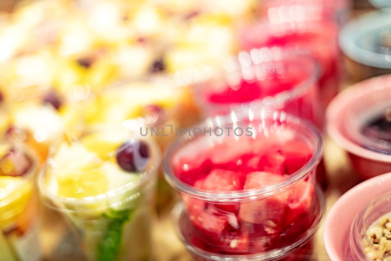 Pre-packaged fruit salads displayed in a commercial refrigerator