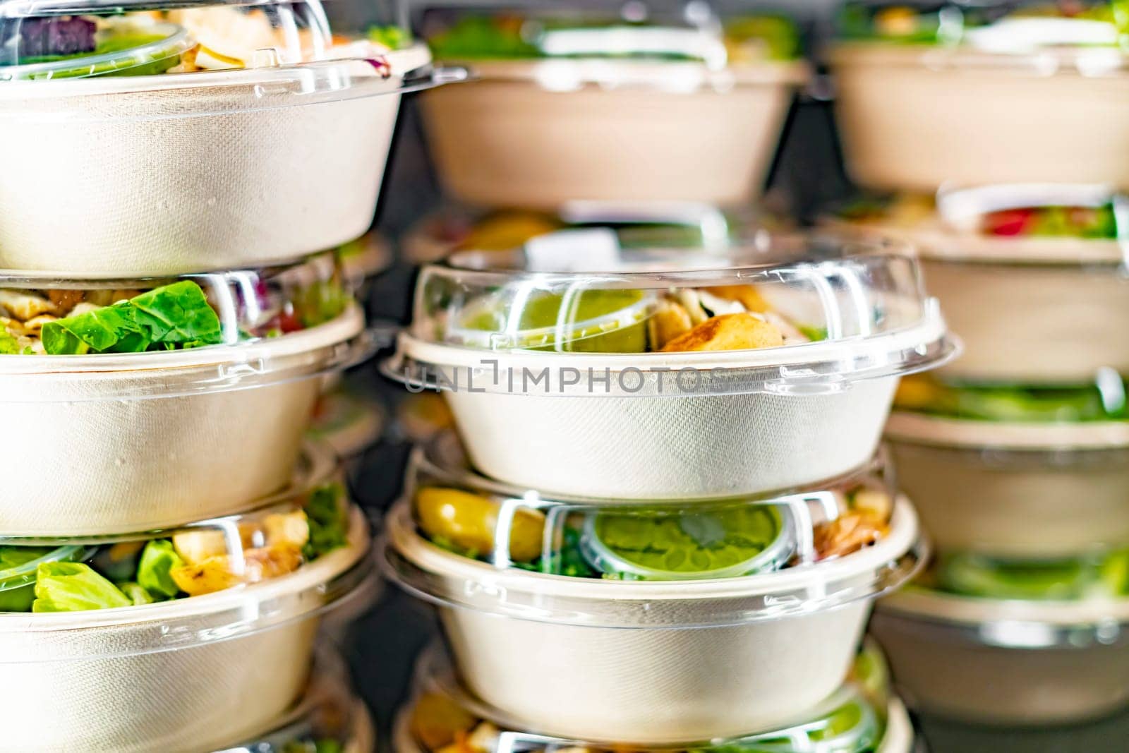 Pre-packaged ready to eat meals displayed in a commercial refrigerator