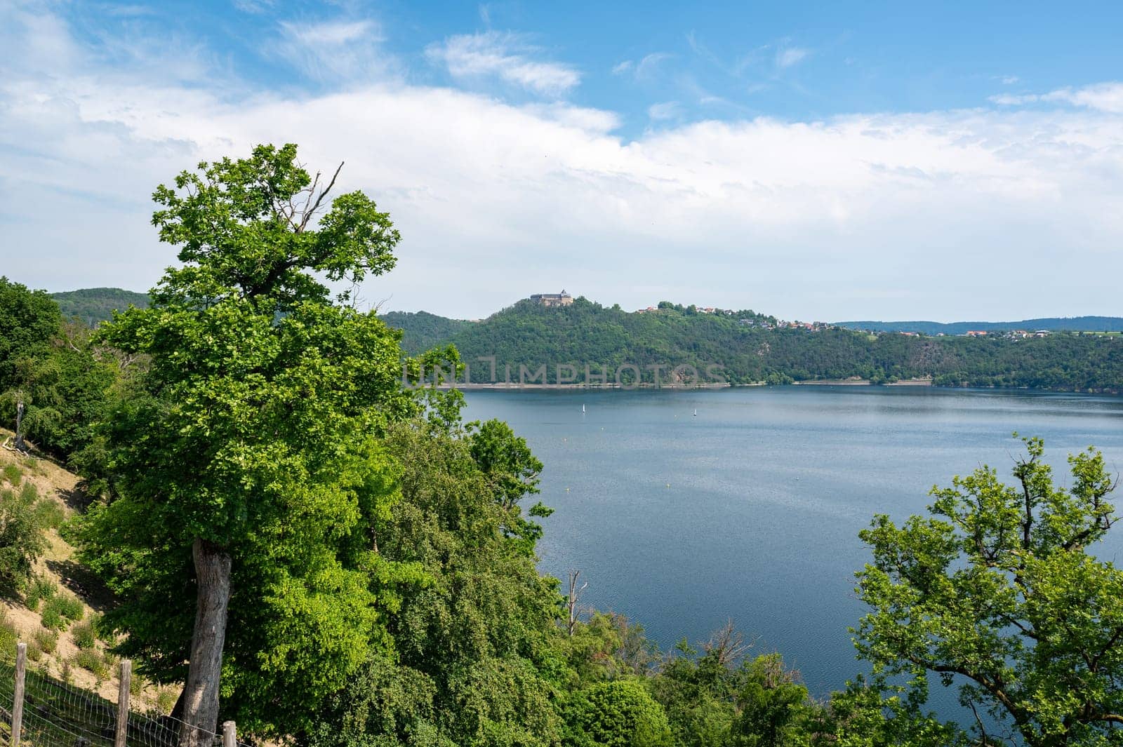 View of the Lake Eder, with a view of a castle, with blue sky and clouds, Hesse, Germany