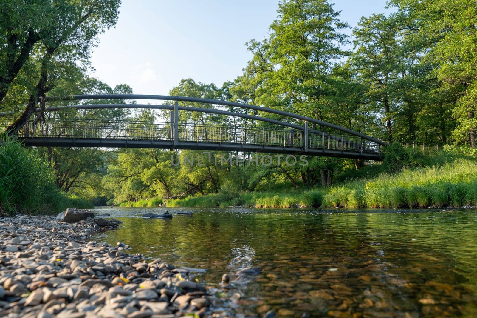 View of the water of the Eder River in Germany, from the bank with a bridge