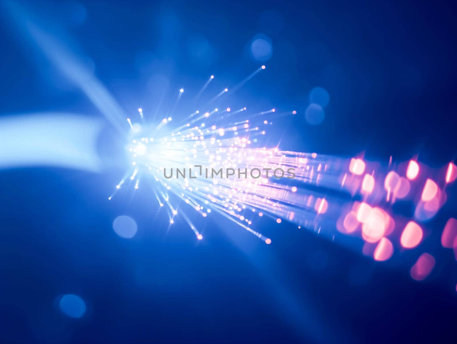 Macro image of a fiber optic cable emitting blue light particles , representing high-speed data transfer.Tech industry advertisements, internet service promotions
