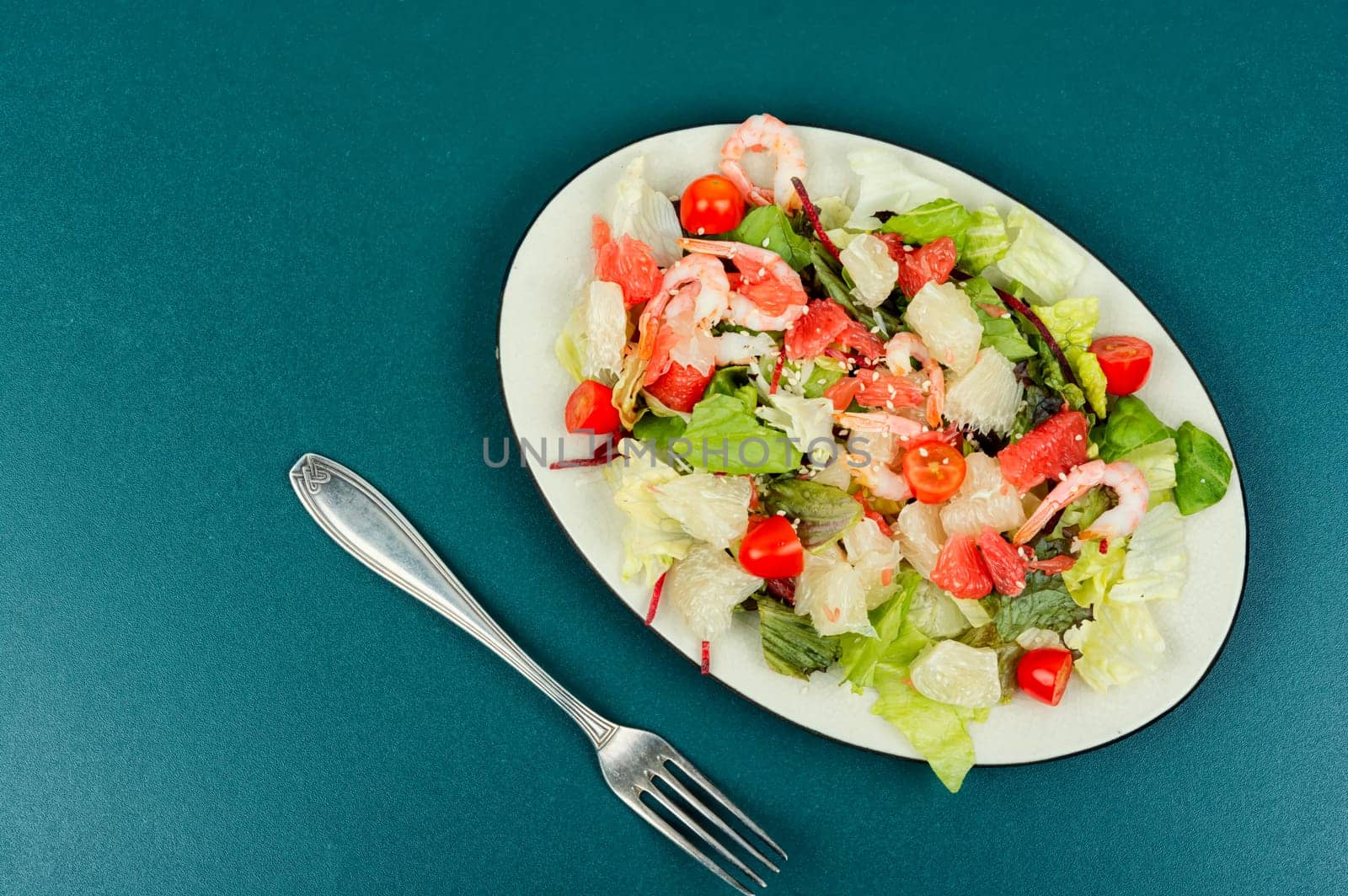 Tasty salad with pomelo, shrimps and greens. Thai appetizer salad.