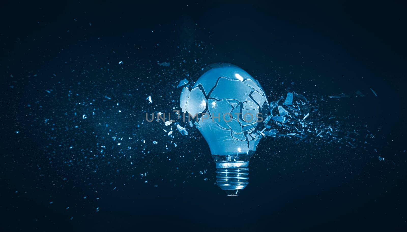 High-speed capture of a light bulb exploding into fragments, symbolizing failure and breakthrough