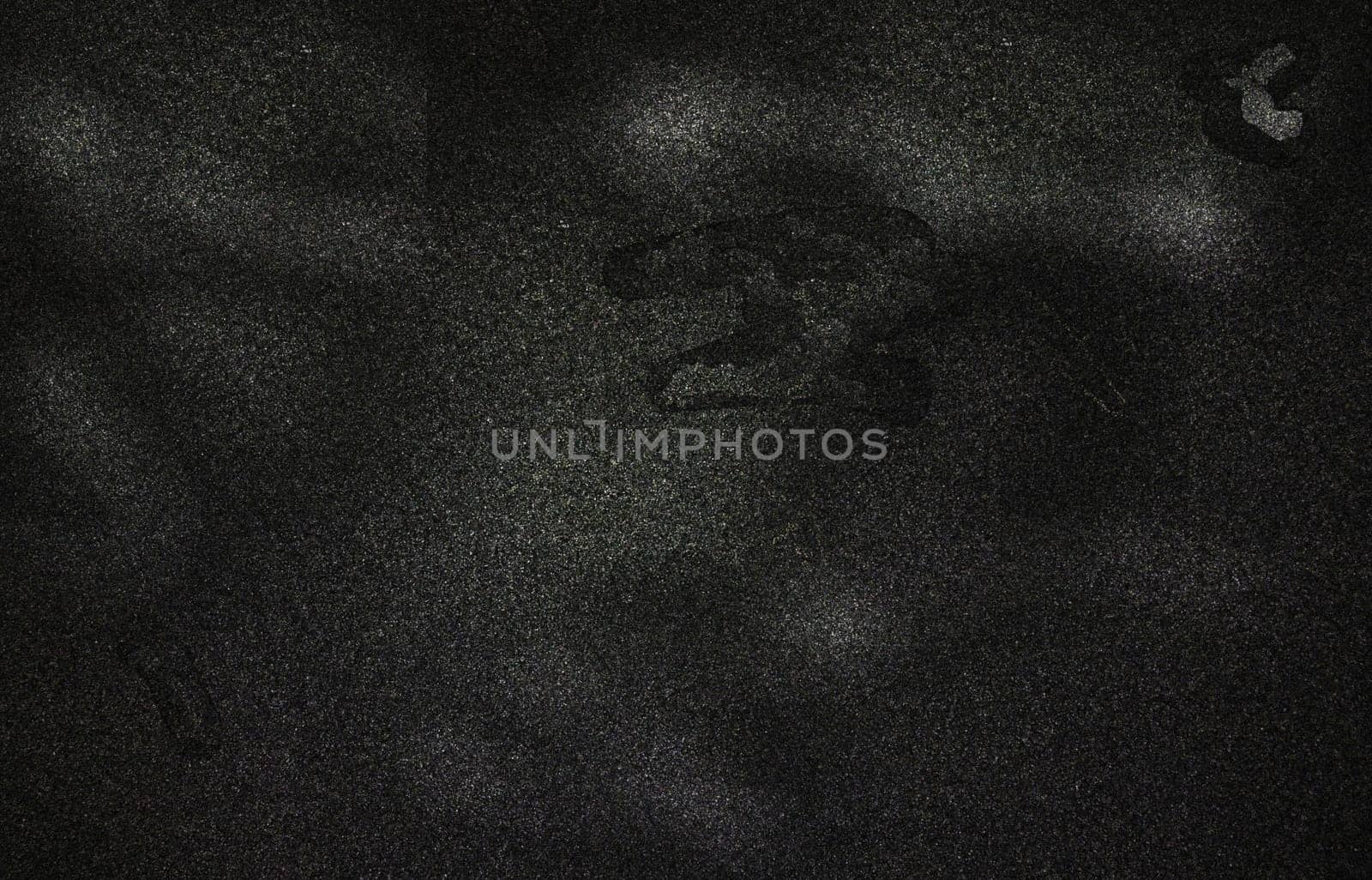 The background texture of a rough monochrome surface with spots and irregularities