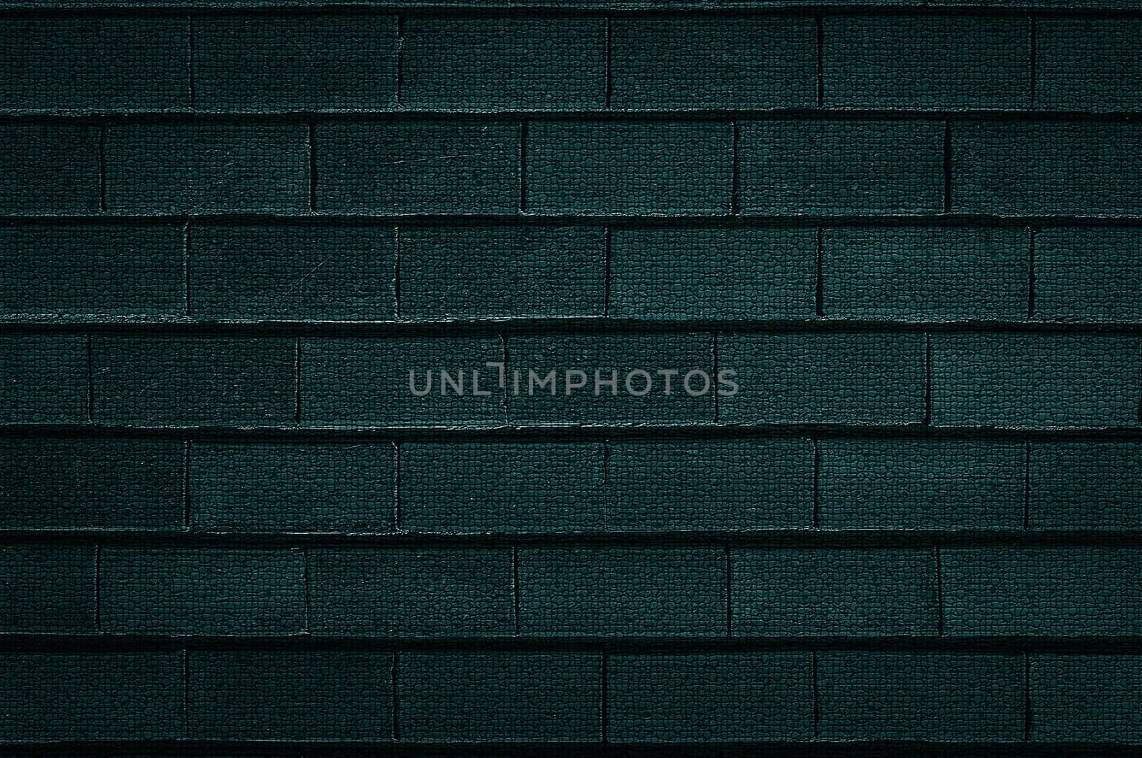 The background texture of an old rough brick wall is dark green in close-up