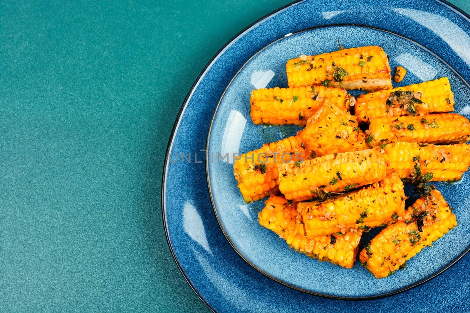 Delicious grilled corn with spices and herbs. Vegetarian food, recipes.