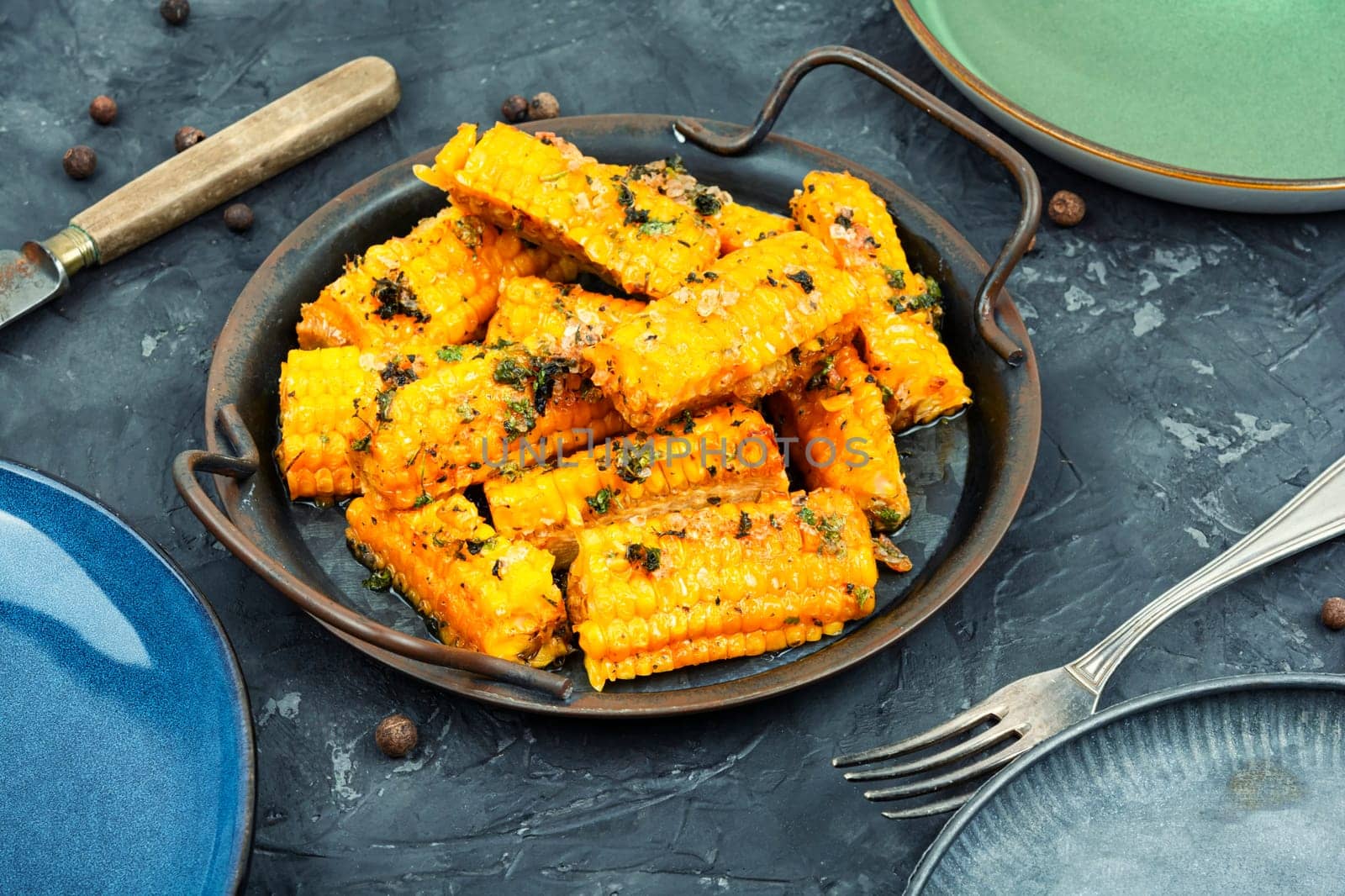 Delicious grilled corn with spices and herbs. Vegetarian food, recipes.