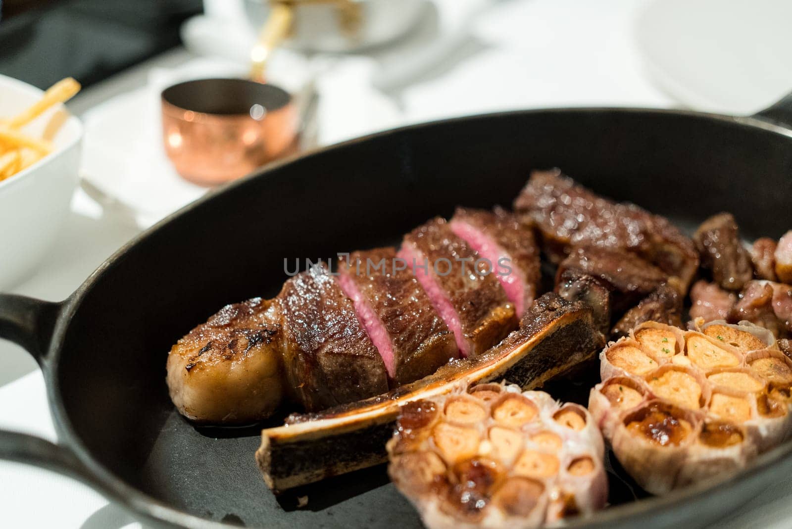 Juicy steak sliced on the cast iron