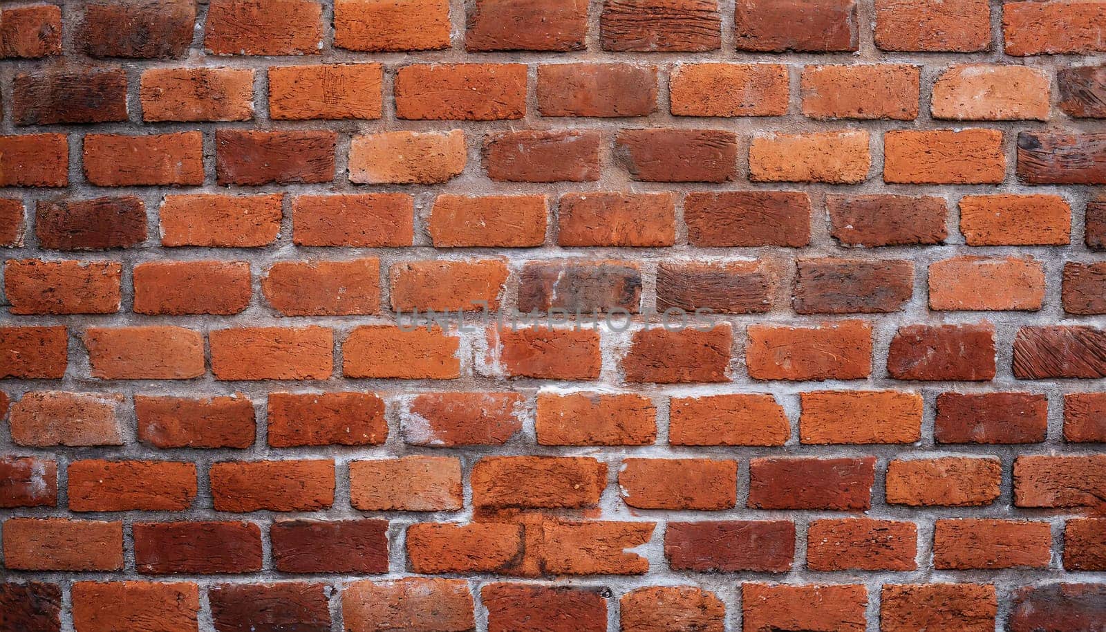 Close up view of a red brick wall. Texture of old dark brown and red brick wall panoramic background. Minimal pattern background concept. Trendy brick wall background idea. Copy space.