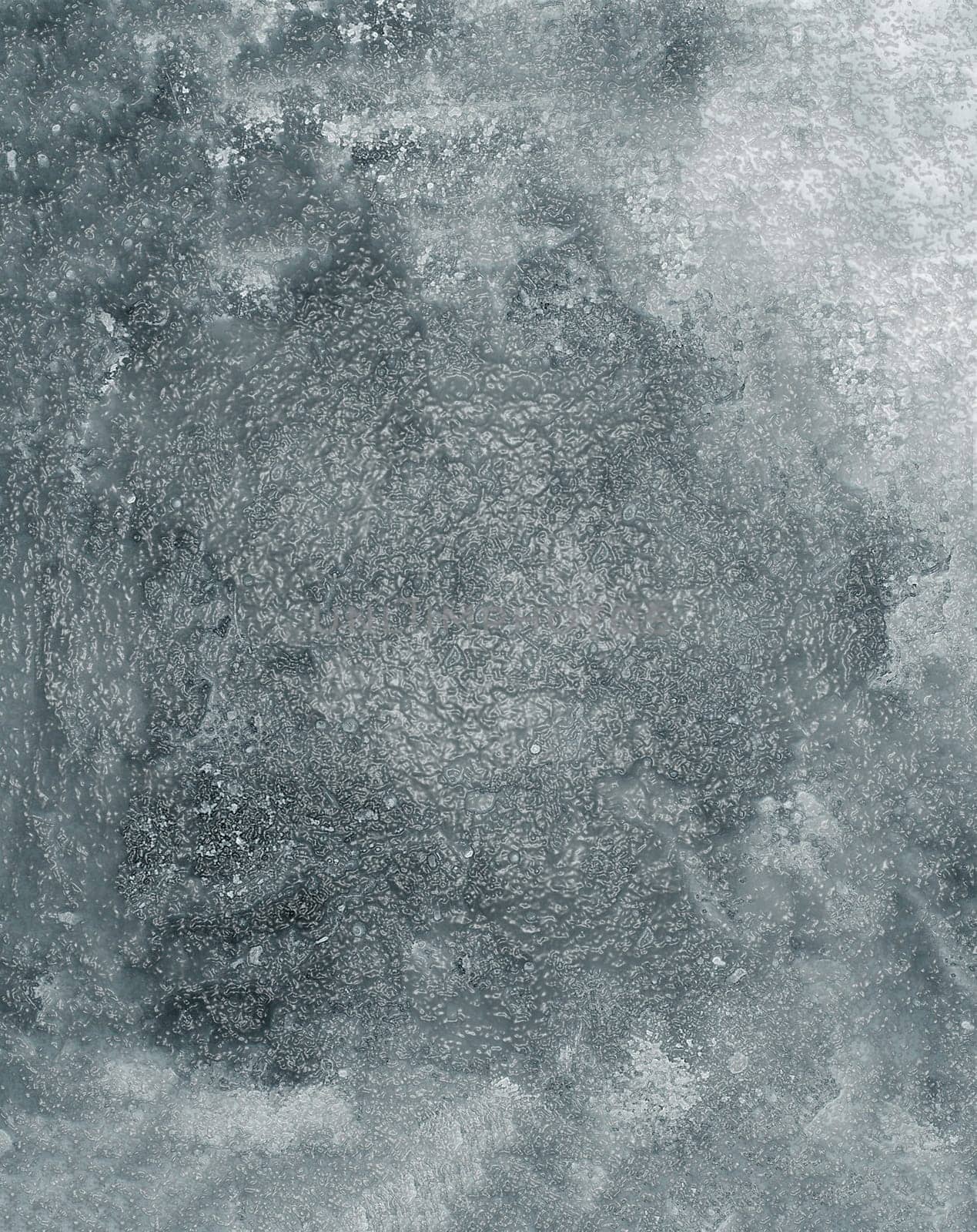 The texture of an old glossy rough wall with spots and irregularities on the surface in close-up