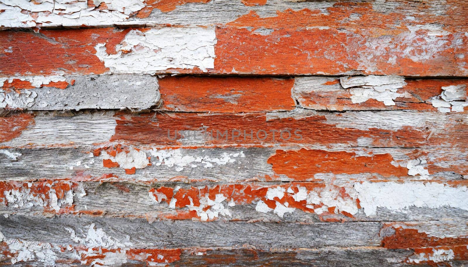 Light blue red and green weathered wooden background with cracked paint.