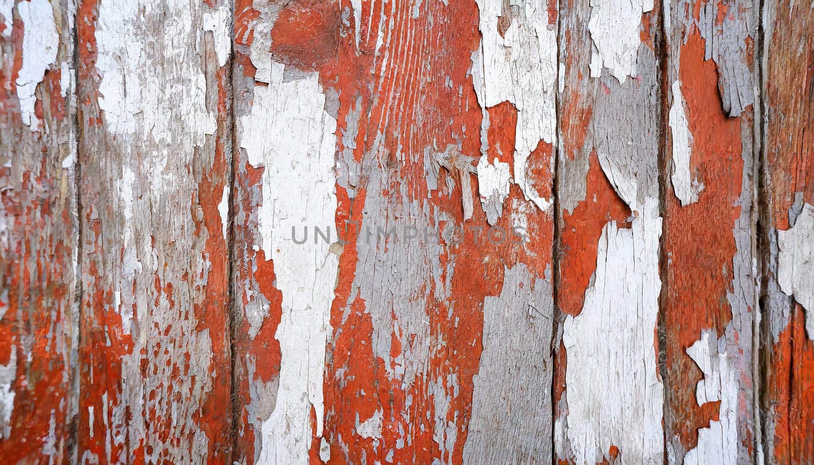 Light blue red and green weathered wooden background with cracked paint.