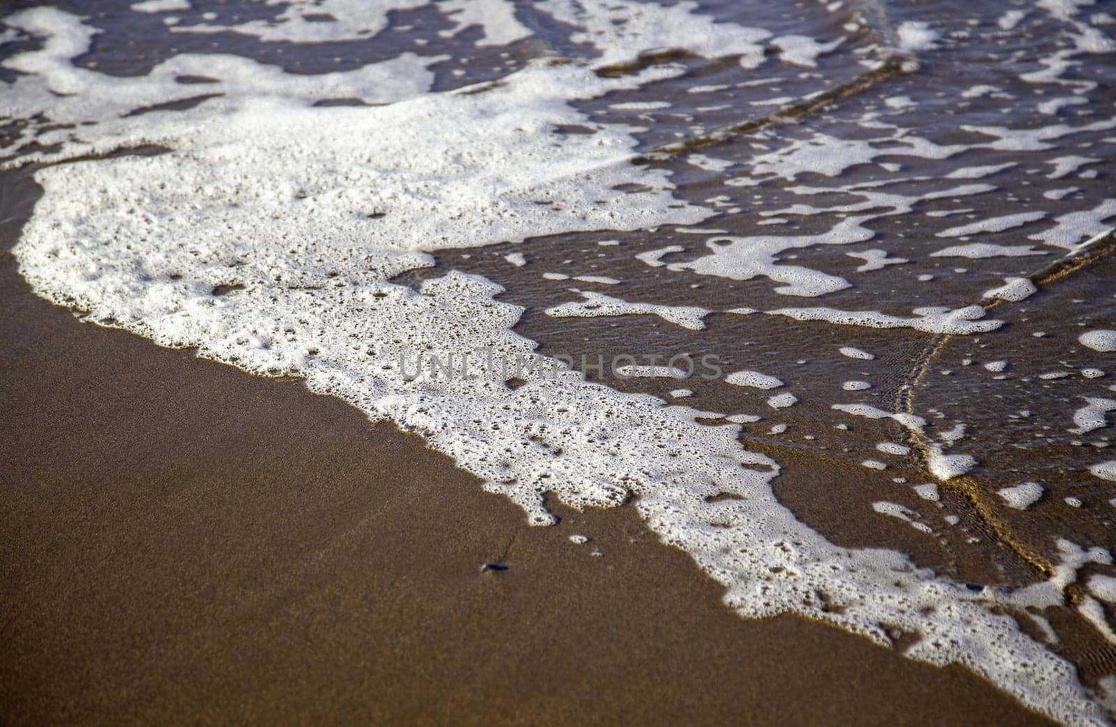 Detail of sea waves on a beach in Spain