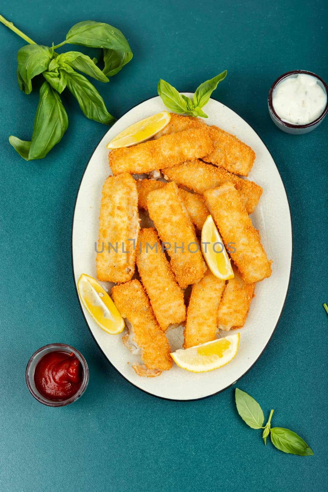 Delicious fish fingers or nuggets, crispy fish steak on the plate.
