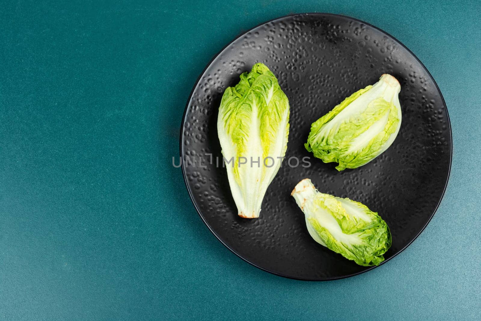 Raw green Romaine lettuce hearts. Baby cos lettuce leaves.