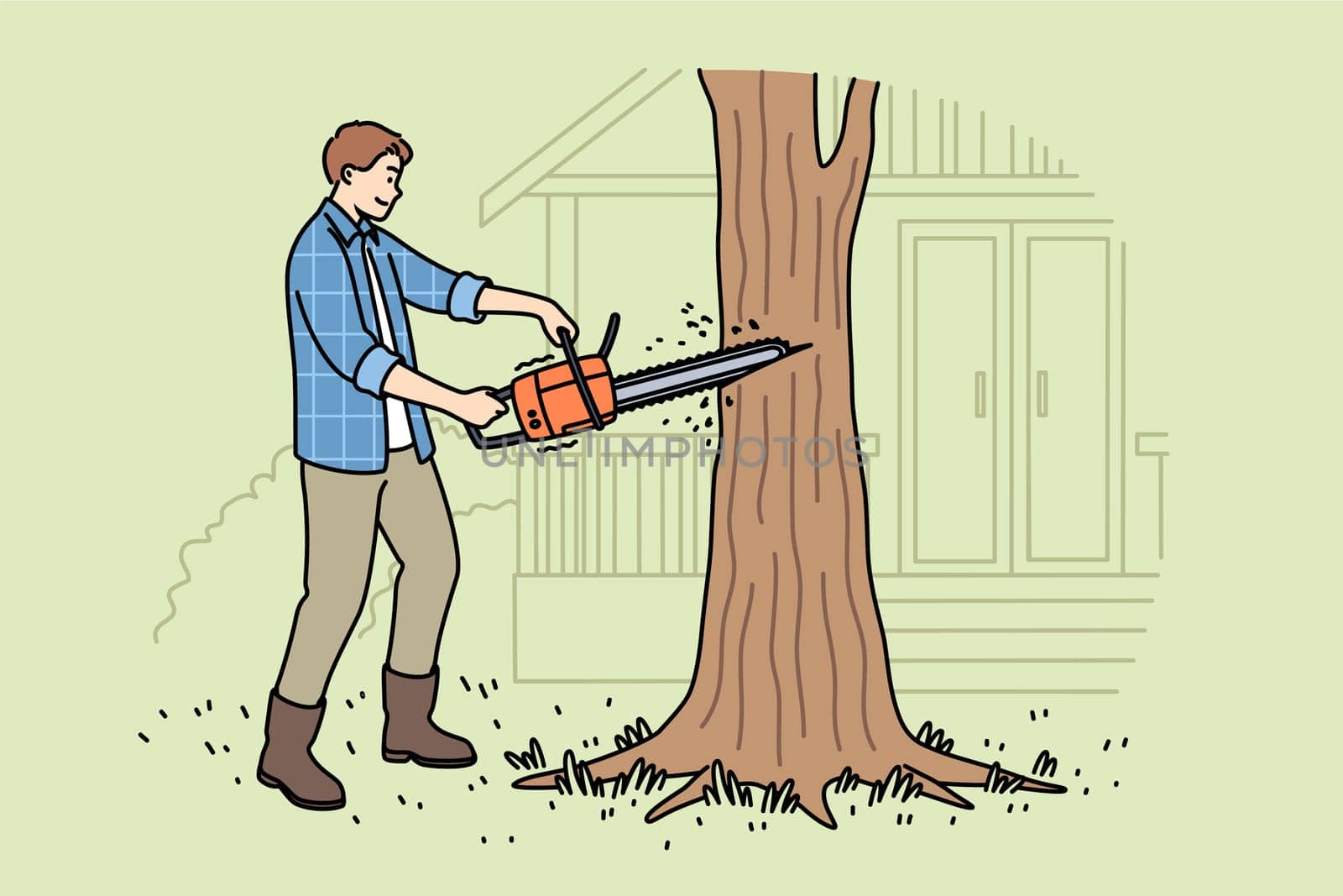 Man lumberjack uses chainsaw to get rid of old, diseased tree growing near house. Young guy works as lumberjack and helps residents of country cottages clear area of unnecessary trees.