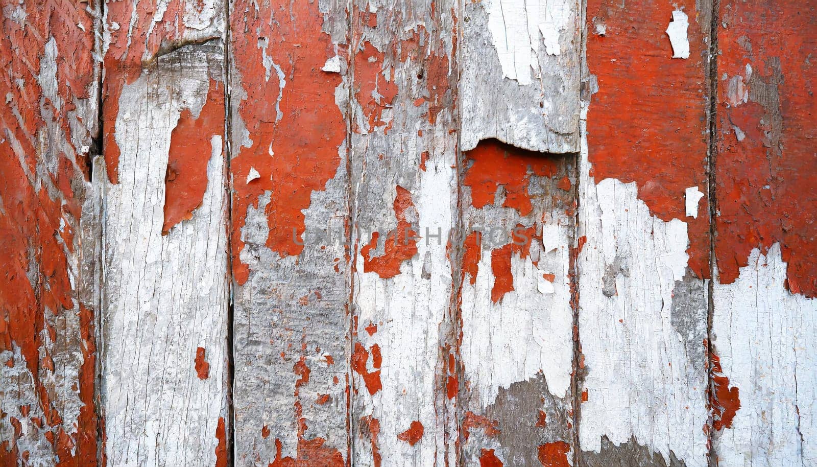 Light blue red and green weathered wooden background with cracked paint.