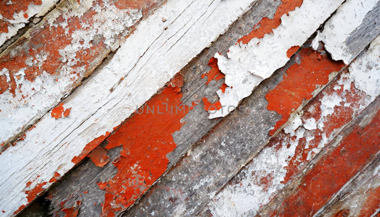 Light blue red and green weathered wooden background with cracked paint.