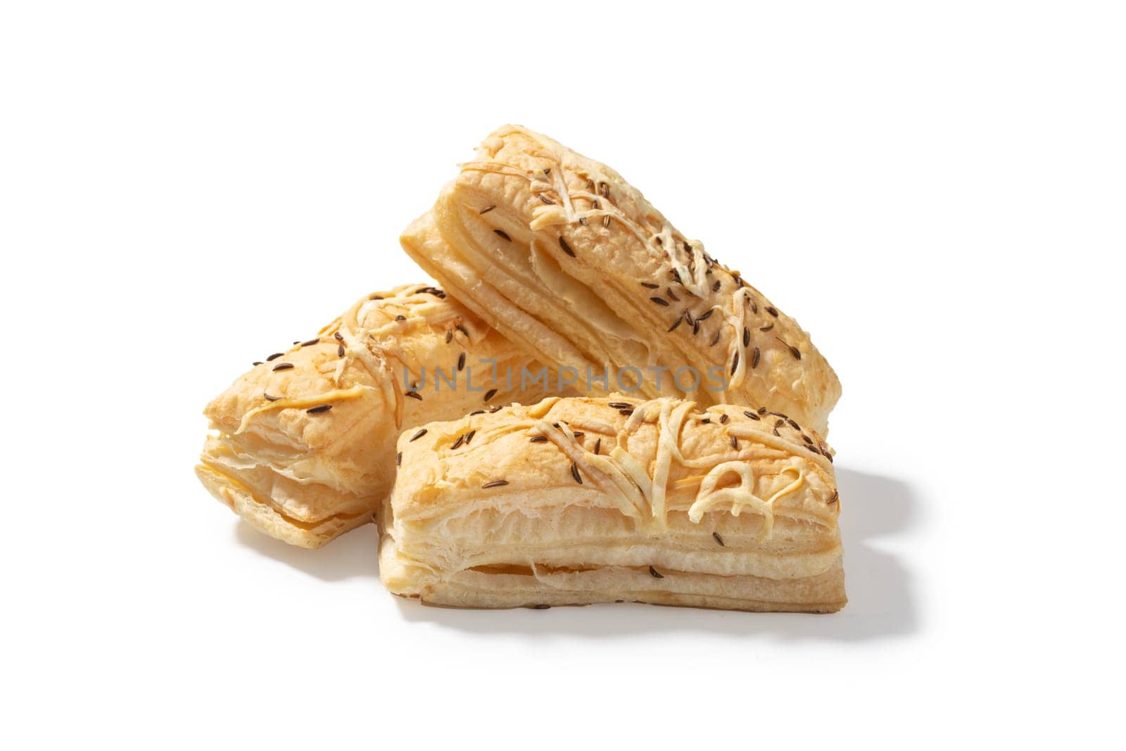 Three delectable cheese crackers, each adorned with a savory blend of cheddar. A delightful trio perfect for elevating your snacking experience
