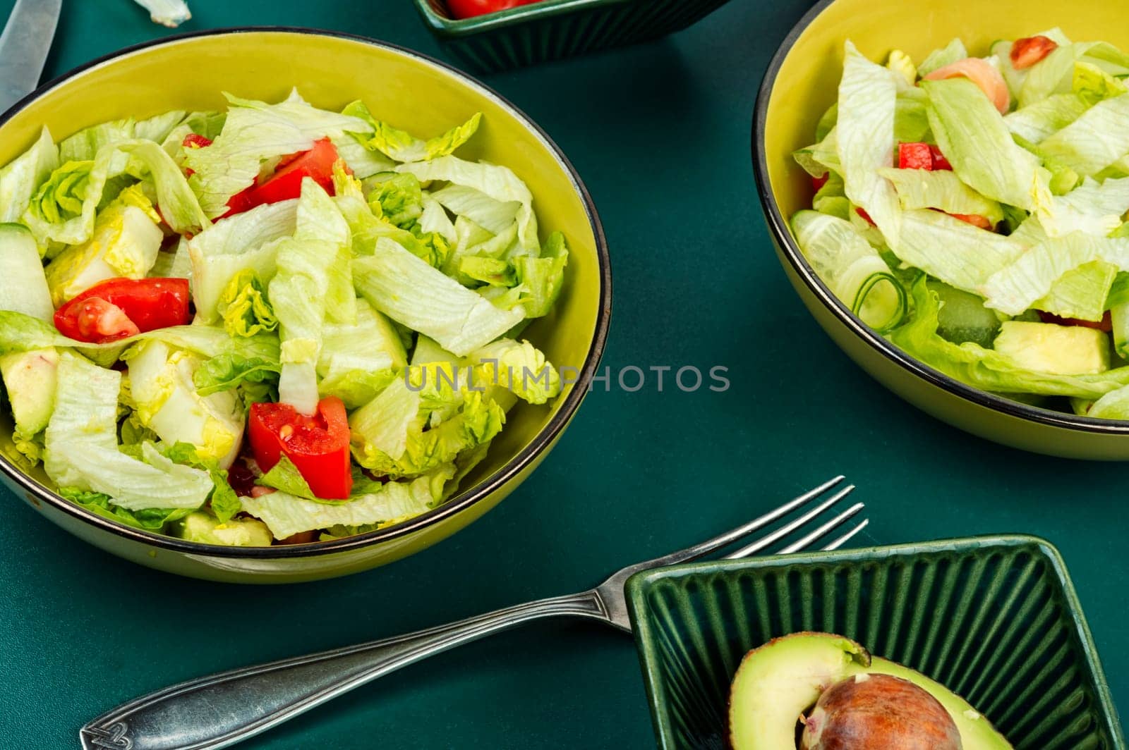 Green vegan salad made from a mixture of green leaves and vegetables. Top view.
