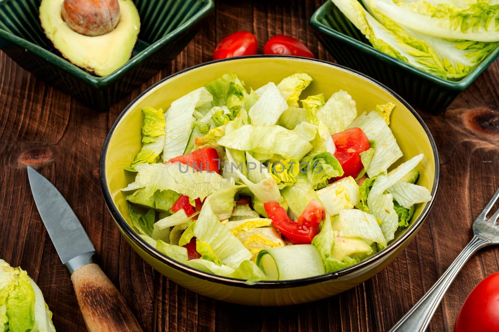 Green vegan salad made from a mixture of green leaves and vegetables. Top view.