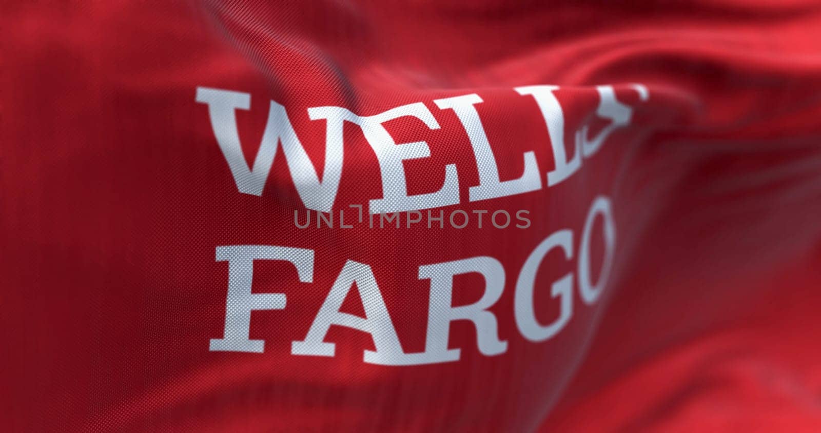 San Francisco, US, Mar. 5 2024: Close-up of Wells Fargo bank flag waving. Finance and banking Illustrative editorial 3d illustration. Selective focus