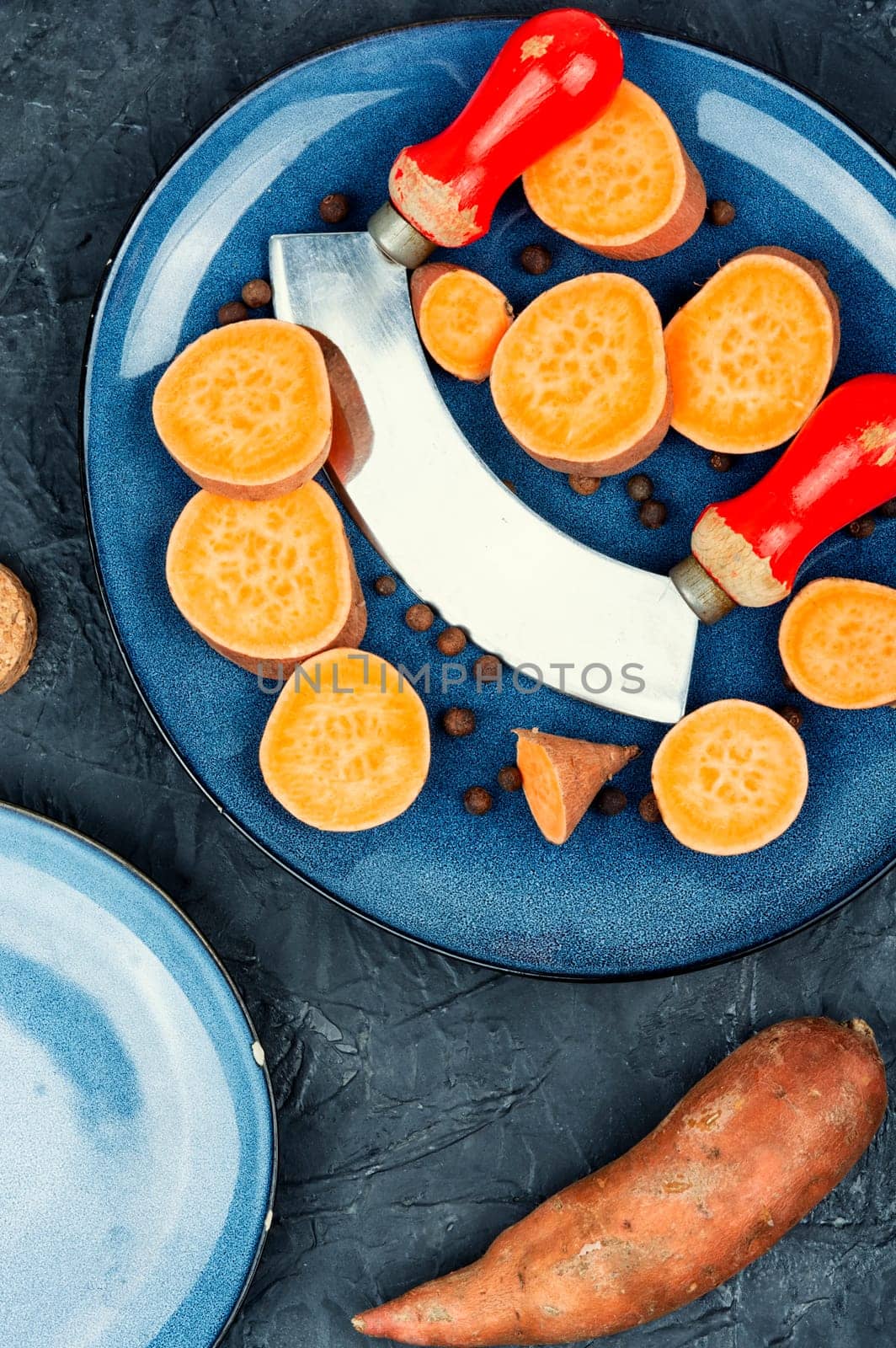 Sliced fresh sweet potatoes for cooking. Orange kumara, yam. Healthy eating.
