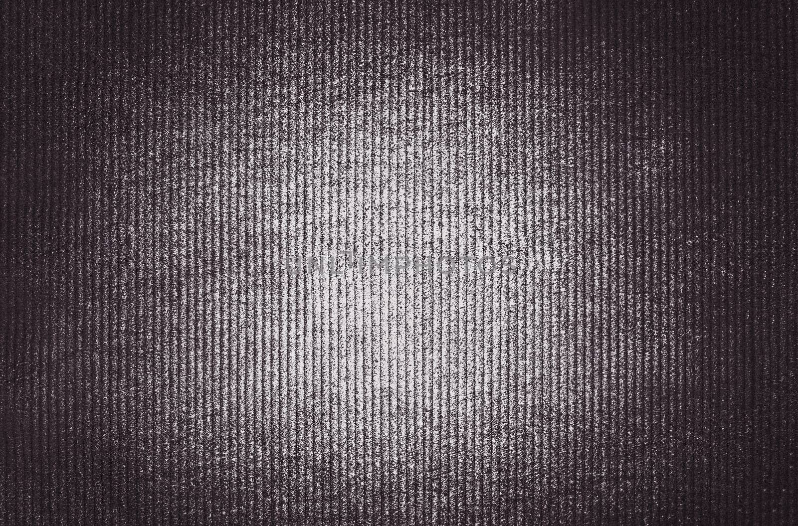 A brown image of convex vertical stripes with an illuminated center and a shadow at the edges