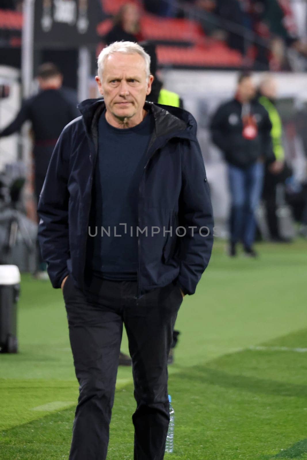 Coach Christian Streich (SC Freiburg) on his way to a TV interview ahead of the Europa League match - Round of 16: SC Freiburg vs West Ham United