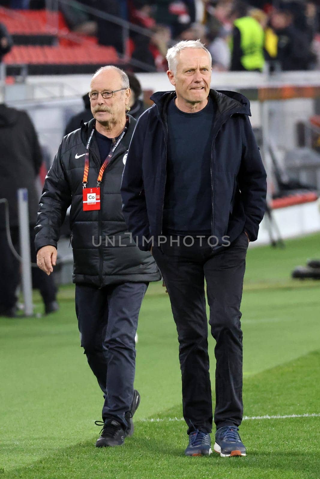 Coach Christian Streich (SC Freiburg) on his way to a TV interview ahead of the Europa League match - Round of 16: SC Freiburg vs West Ham United