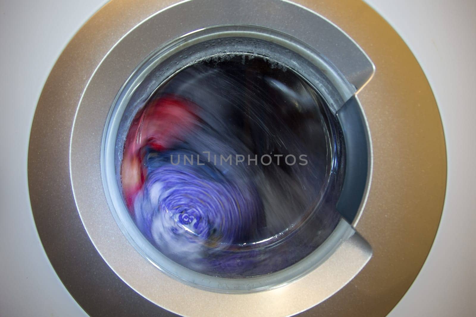 a close view of domestic washing machine at work.