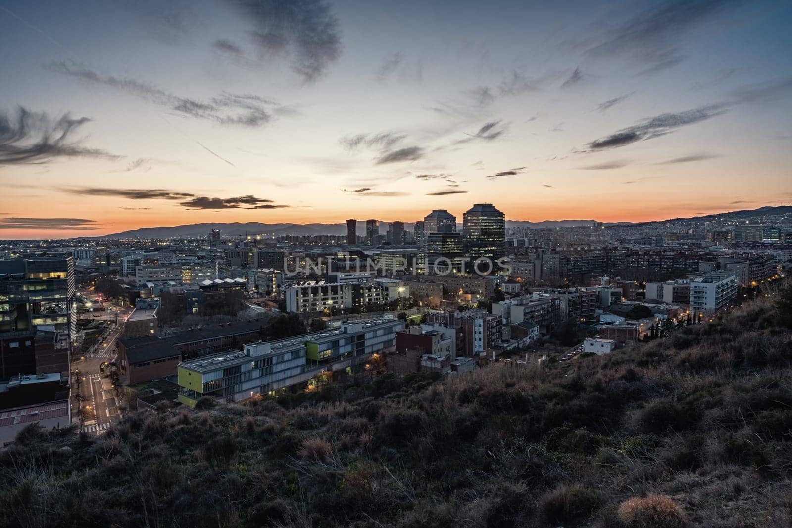 Panoramic view at dusk of La Marina de Port, a quarter of the Sants-Montjuic district, located in the south-west of Barcelona and bordering Hospitalet de Llobregat, a city that is the second largest municipality in Catalonia in terms of number of inhabitants.