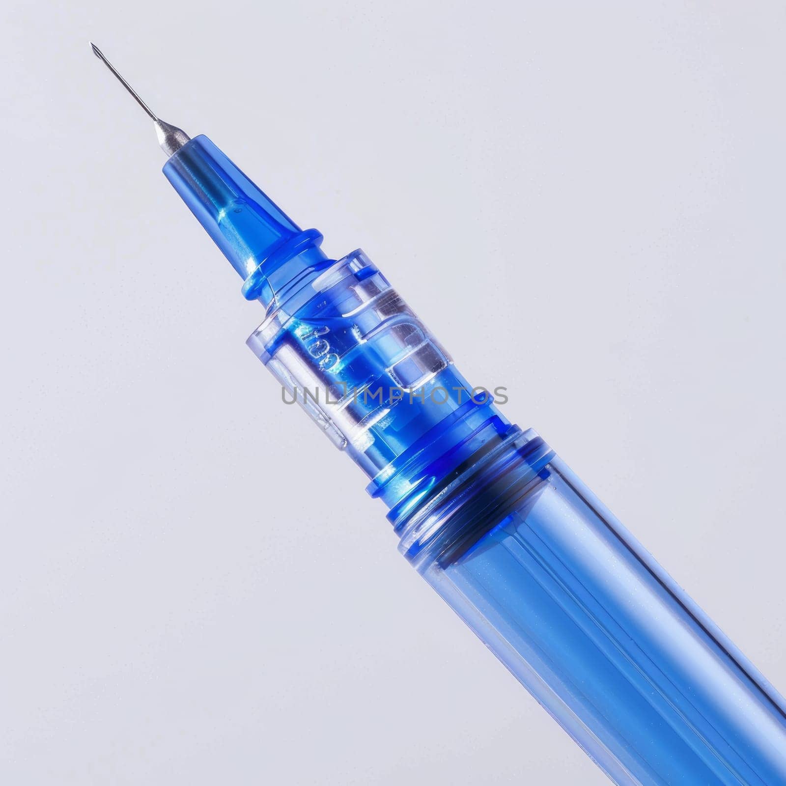 Close-up of a blue syringe with a sharp needle, isolated on a light background