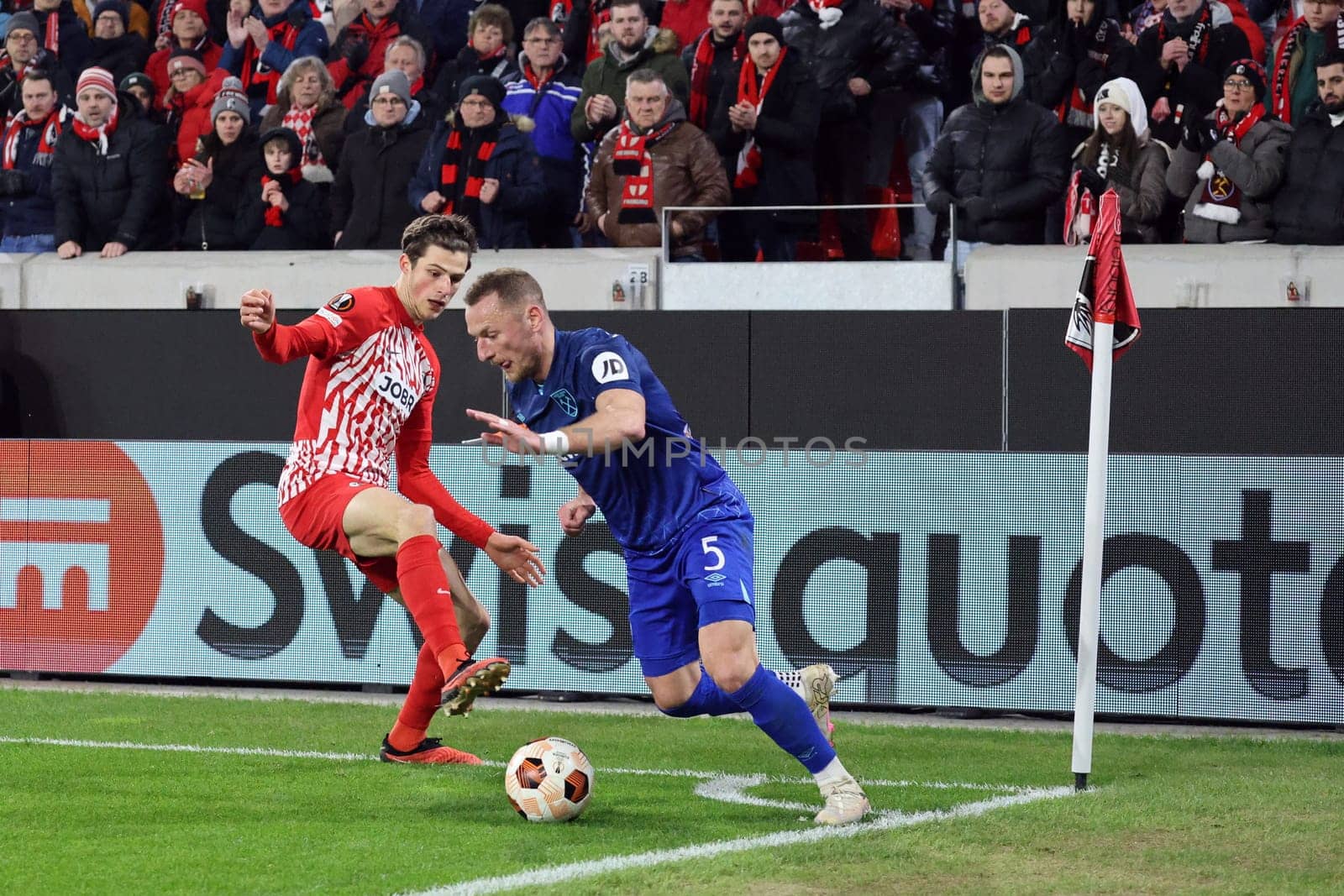 Merlin Röhl (SC Freiburg) duels with Vladimír Coufal (West Ham United) at the corner flag at the Europa League match - Round of 16: SC Freiburg vs West Ham United
