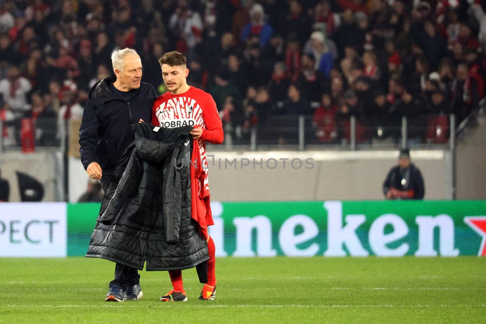 Coach Christian Streich (SC Freiburg) congratulates the young winter signing from Paderborn,Florent Muslija (SC Freiburg) on his successful performance in the Europa League round of 16 match: SC Freiburg vs West Ham United