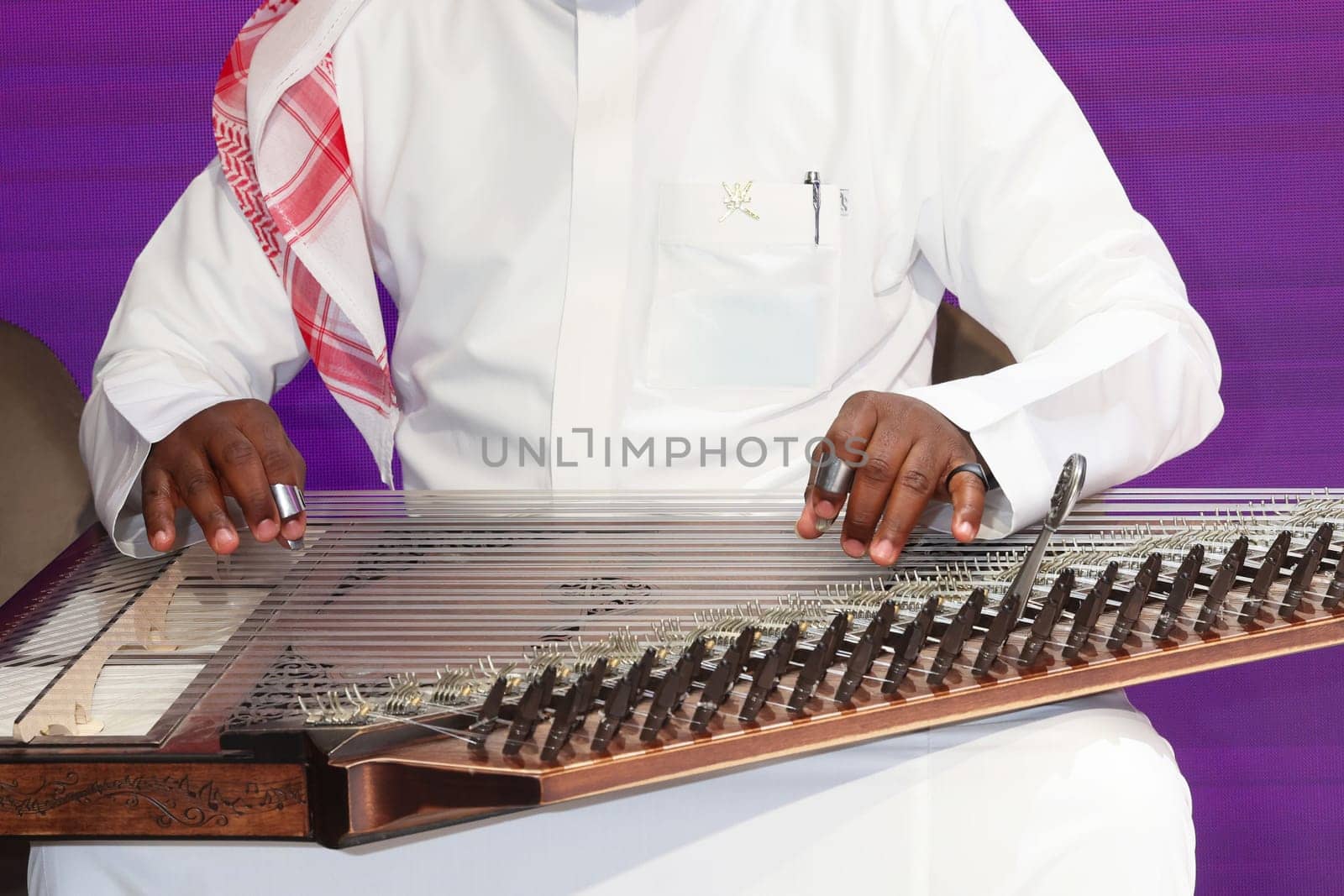 A musician playing qanun