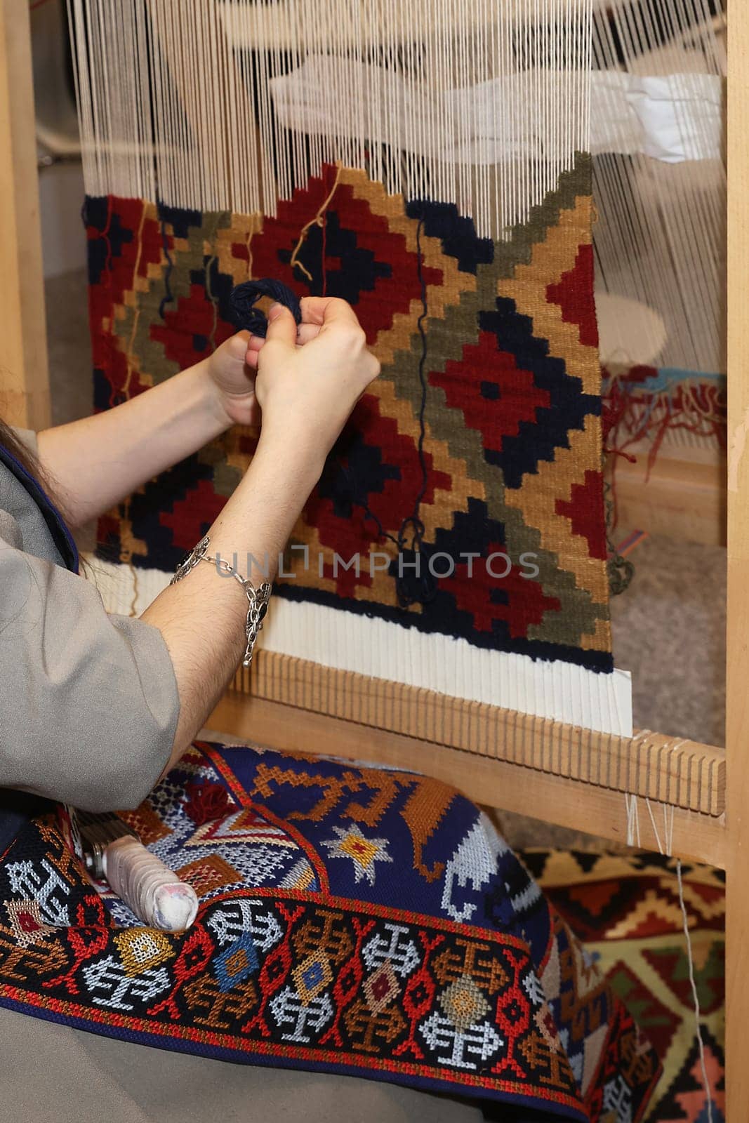 A woman making a rug