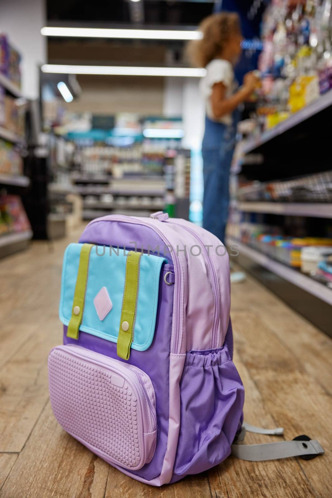 School bag of young female student on blurred background. Great sale choice for study accessories