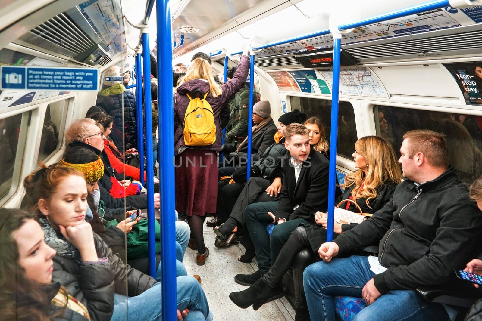 London, United Kingdom - February 02, 2019: Interior of Northern Line underground train with many passengers in winter clothes