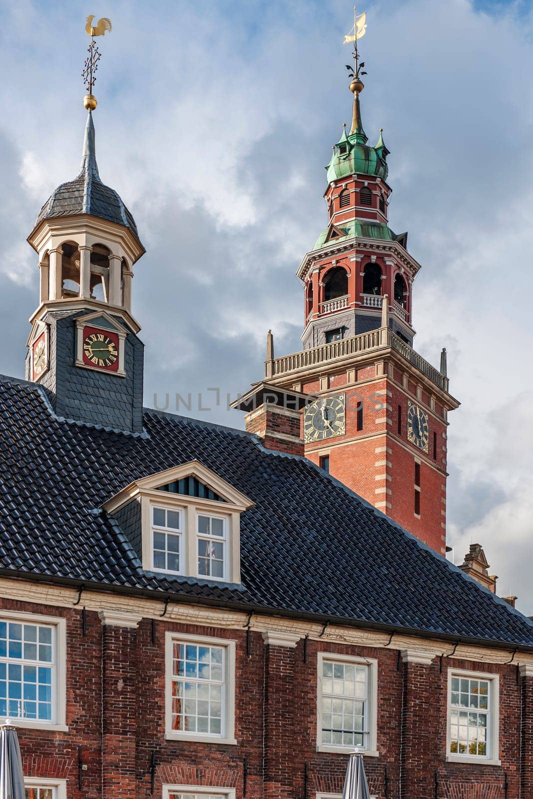 Leer, Germany - September 28, 2022: Traditional architecture with the old scales in the foreground and the town hall tower protruding above it.