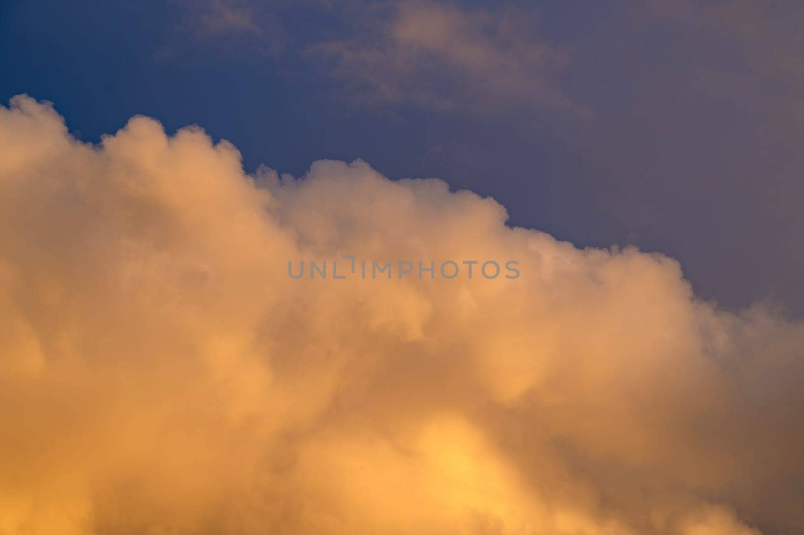 Big yellow cloud in the sky in the evening sun