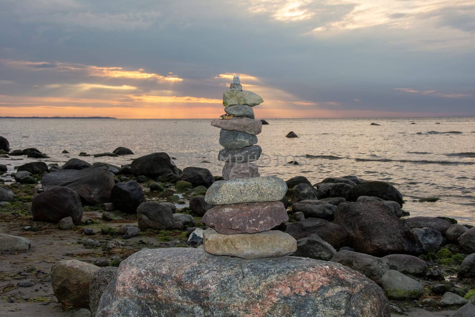 Stacked stones on a beach on the Baltic Sea coast at sunset