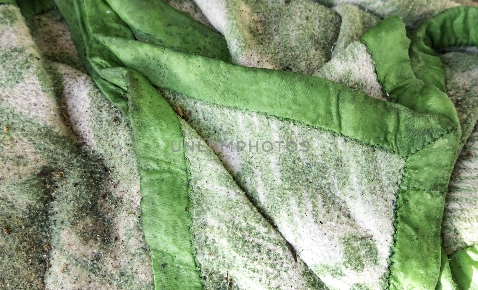 Detail of dirty blanket thrown in the trash, recycling
